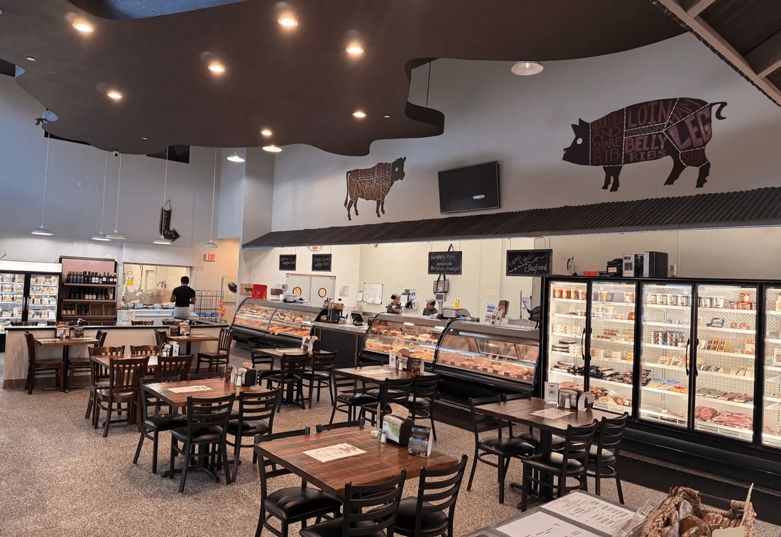 Inside Jimmy P's Butcher Shop & Cafe in Bonita Springs — butcher cases, café tables, and a bright shop floor